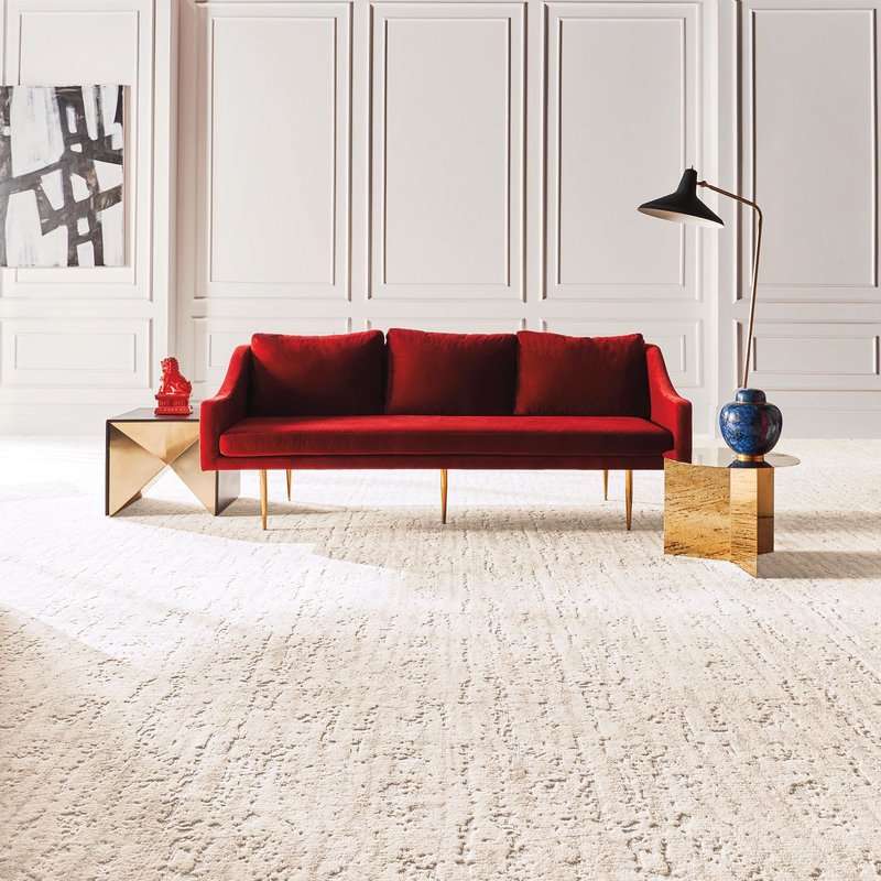 A red couch on a white carpet from Carpet 4 Less in Antioch, CA