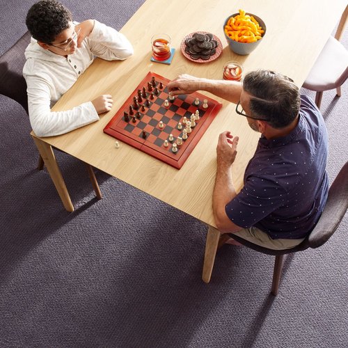 Father playing chess with his son from Carpet 4 Less in Antioch