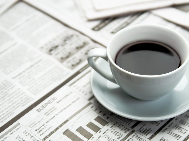 A cup of coffee on the newspaper from Carpet 4 Less in Antioch, CA
