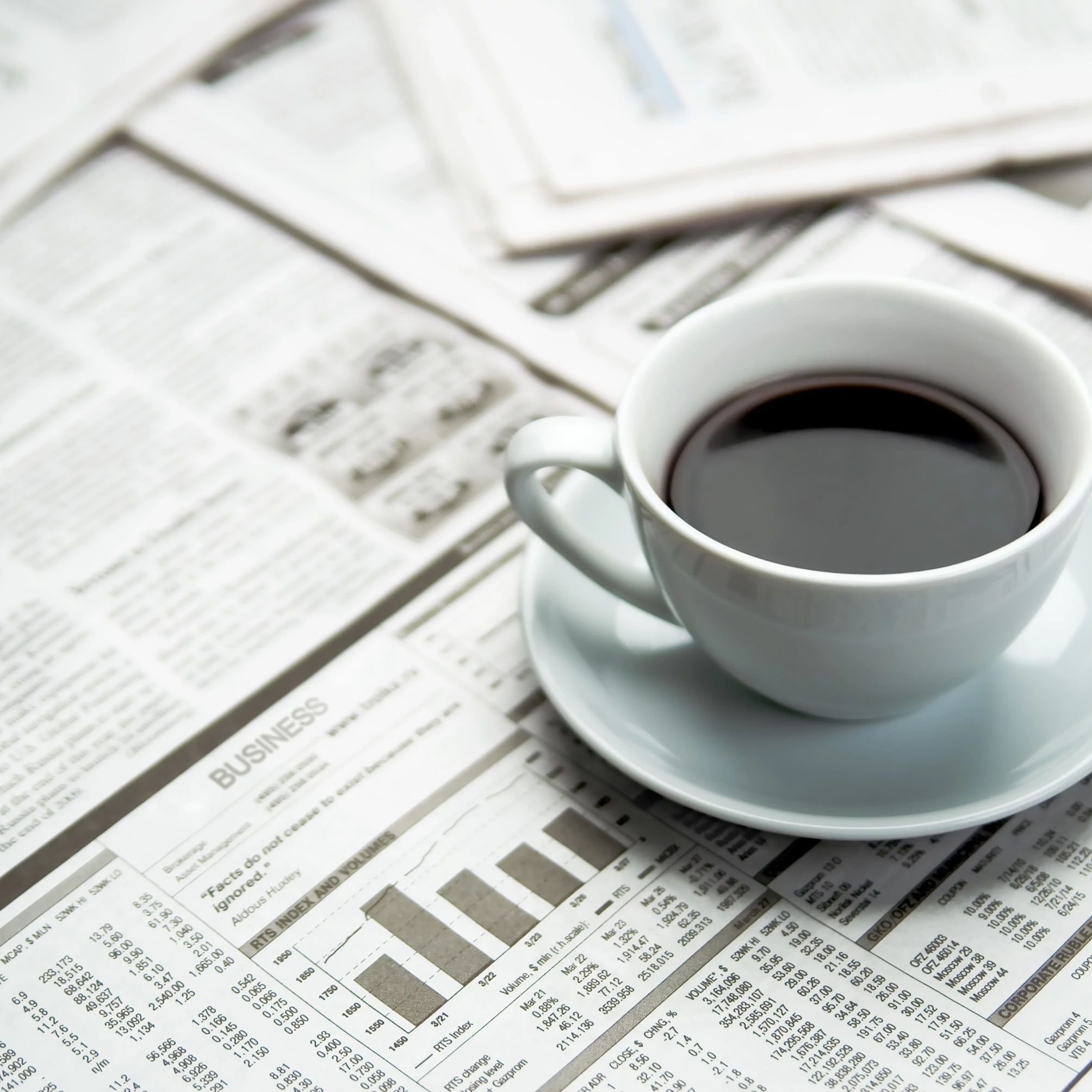 A cup of coffee on the newspaper from Carpet 4 Less in Antioch